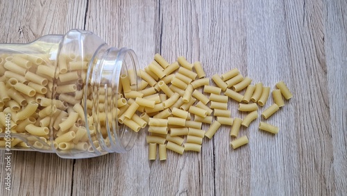 Pasta spilled from a jar onto the table