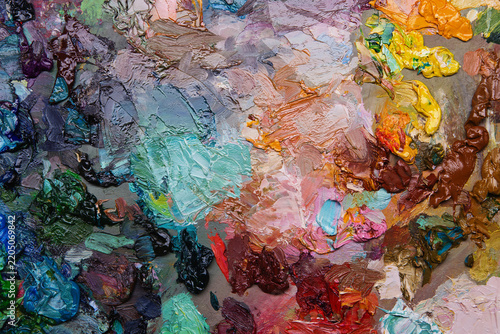 Messy colorful artist oil paint mixing palette. Vibrant abstract textured acrylic color swatches for creative art studio design