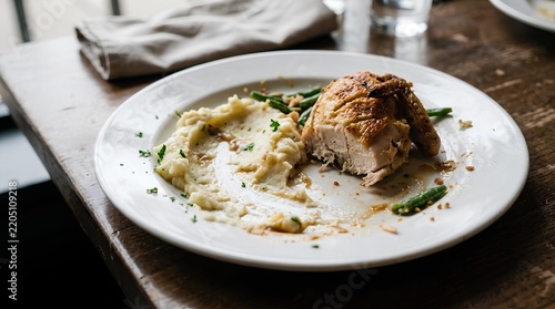 Half Eaten Roasted Chicken Breast with Mashed Potatoes and Green Beans