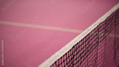 Close up view of pink padel tennis court with net and court lines, representing modern racket sports, sports facilities and recreational activities