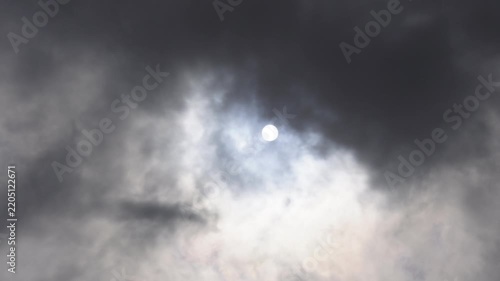 Dramatic sunlight bursting through dark storm clouds