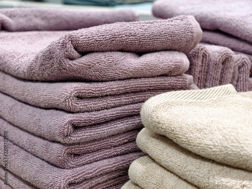 Canvastavla Purple towels neatly stacked on home goods store counter