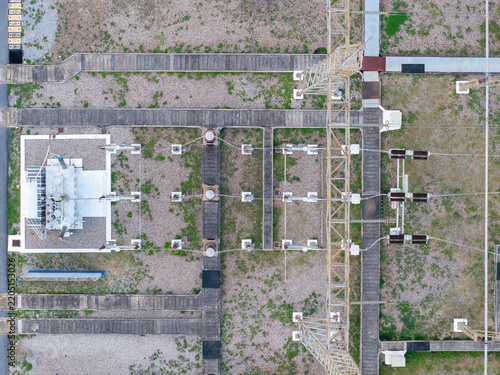 Aerial view of a high-voltage main inlet substation with metal transmission towers, concrete walkways, and gravel ground in Central Seberang Perai, Penang, Malaysia.