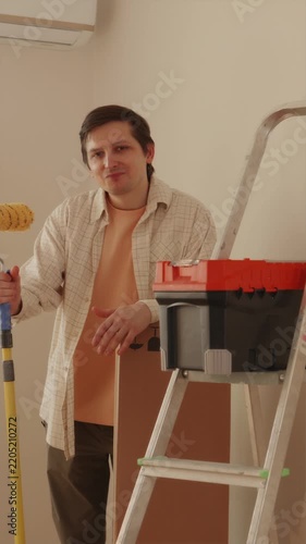 Young man resting after completing room renovation work