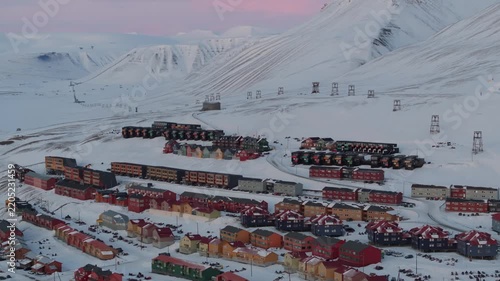 Aerial view of the colorful houses of Longyearbyen nestled in the snowy arctic landscape, Longyearbyen, Svalbard, Svalbard and Jan Mayen.