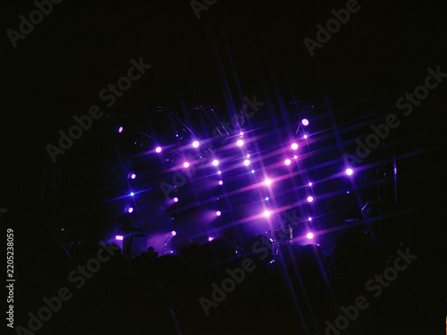 Purple lights illuminate the concert venue at night