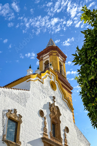 A typical Spanish church showcases traditional religious architecture with a distinctive facade, bell tower and historic cultural character
