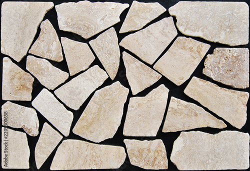 Beige travertine irregular stone mosaic texture on black background