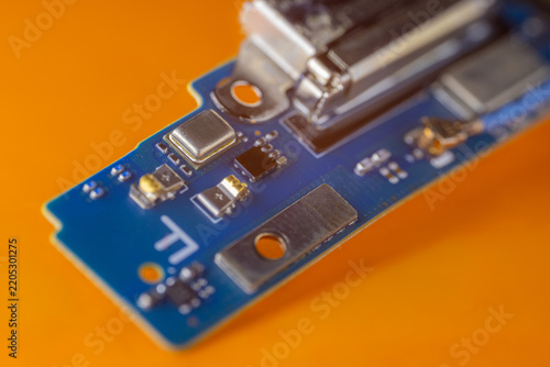 Obraz na plátně Blue electronic circuit board with metal contact plates, integrated components,