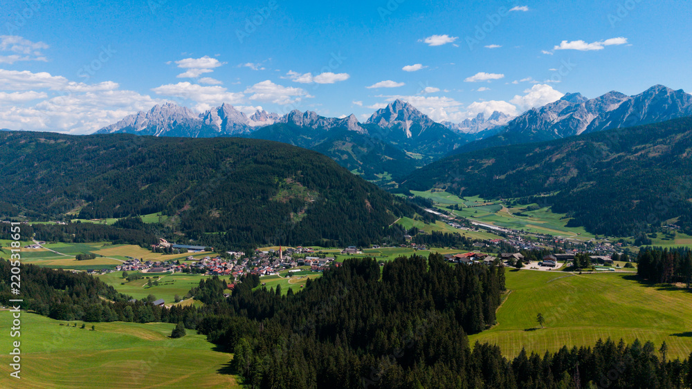 Obraz premium Majestic scenery of rough mountain ridge near grassy hills 
