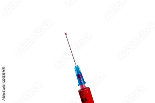Red medical syringe with a sharp needle and blue protective cap against a clean white background, isolated product 