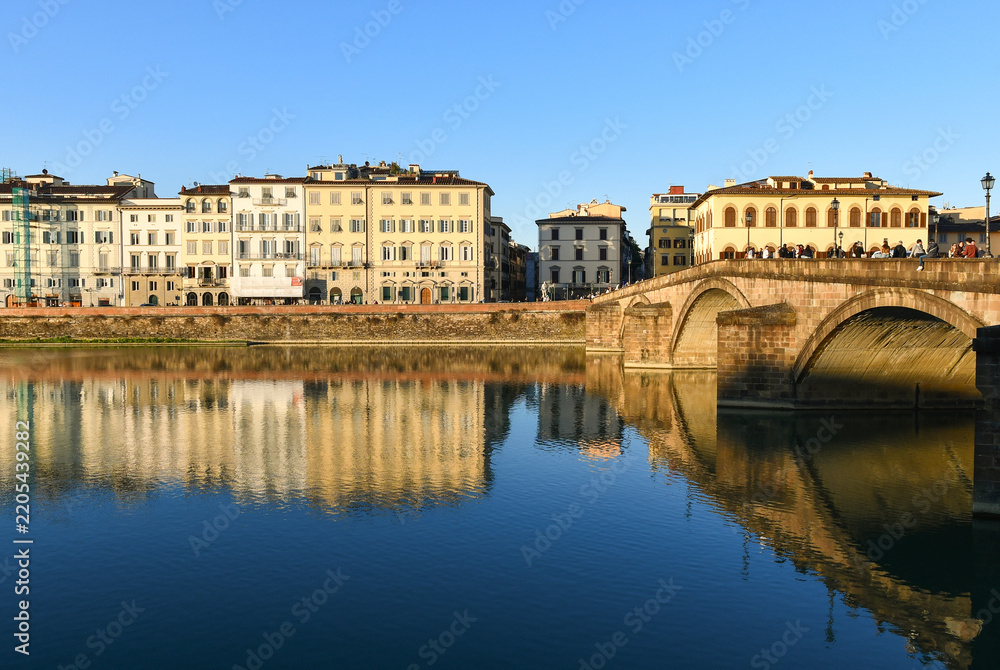 Fototapeta premium Scenic view of Ponte alla Carraia bridge over Arno River with historic buildings reflection, Florence, Tuscany, Italy