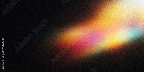 Abstract colorful light leak overlay on black grainy texture background