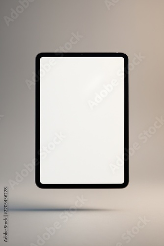 Floating tablet with blank screen.