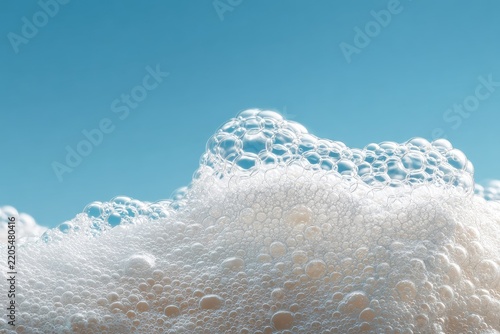 Close-up of frothy white bubbles against a clear blue sky, showcasing their texture and translucent quality