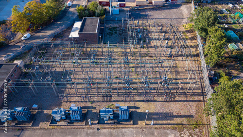 Aerial view of an electricity sub station with industrial transformers and electrical infrastructure in a fenced compound in Camberley, England, United Kingdom.