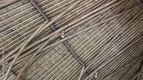 Traditional bamboo roof structure with natural woven materials, showcasing rustic architecture, craftsmanship, and sustainable design.