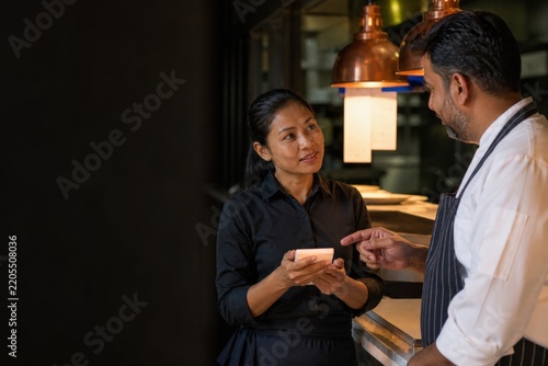Restaurant allergen training server and chef practicing a repeat-back confirmation