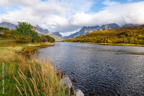 Photography Scenic autumn landscape at Olderfjord with mountains and water in the Lofoten Is