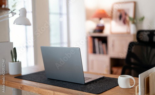 Modern Home Office Workspace with Laptop Coffee Cup and Desk Lamp
