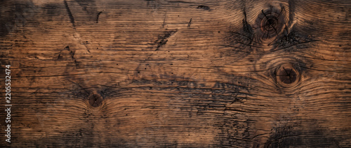 Amber reclaimed wood texture background with prominent circular knots and rough weathered grain for rustic design