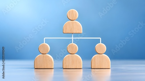 Wooden figures representing a hierarchical organizational structure or team hierarchy symbolizing management and employees on a blue background.