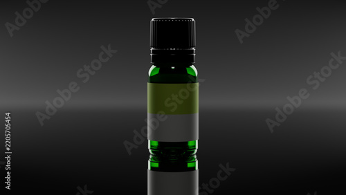 Green essential oil bottle on black glossy reflective surface