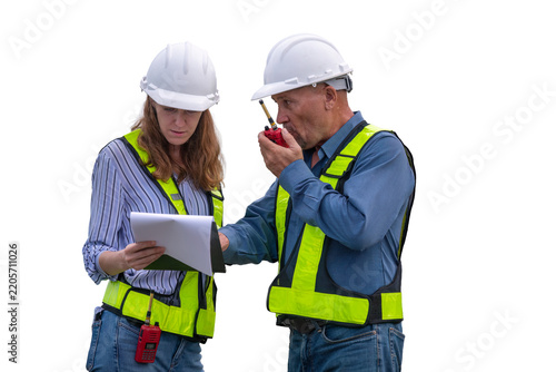 Engineers wearing safety gear, including hard hats examining survey standing industrial facility engaged in a job requires high safety standards concept with PNG white background.	