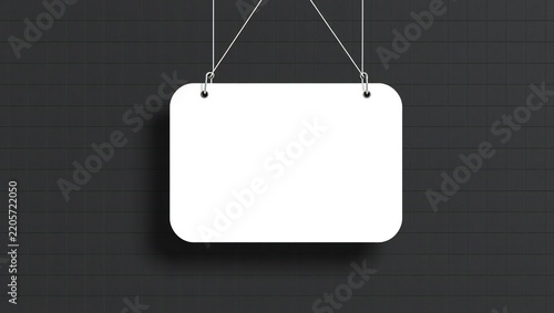 Blank white rectangular sign hanging on a dark grey tiled brick wall