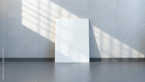Empty vertical canvas frame standing on the floor against a concrete wall with sunlight and shadow