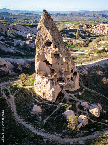 Aerial view of Uchisar Castle, a historic rock-cut fortress carved into volcanic tuff, surrounded by the unique landscape of Cappadocia in Uchisar, Nevsehir, Turkiye.