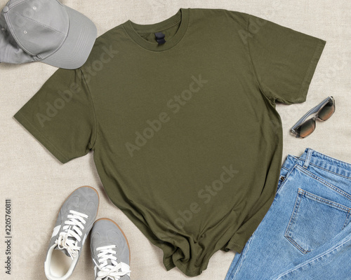 Blank military green unisex t-shirt mockup, crewneck flat lay with denim jeans and mens accessories