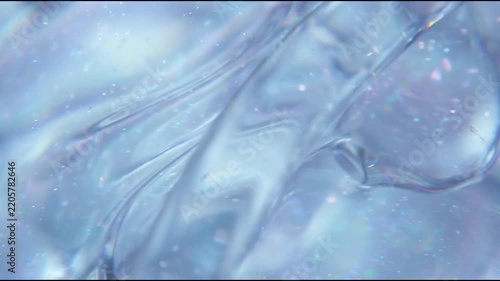 Ophthalmic optics appear as a macro field of translucent pale-blue optical gel with subtle curved