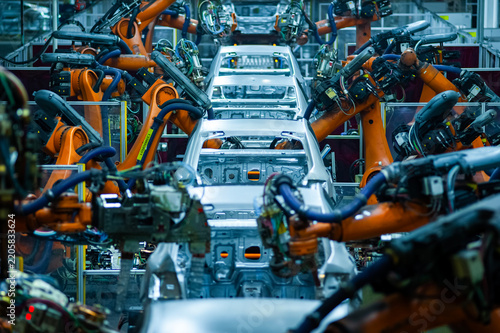 Automated Automotive Welding Production Line with Industrial Robots Processing Car Body in White in Modern Smart Factory