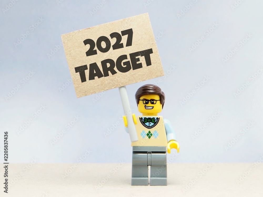 Obraz premium Indonesia - June 12, 2026 : Mini toy of action figure at table with blurred background. Business Miniature photography concept design. Minifigure of people with 2027 PLAN text at paper poster banner.