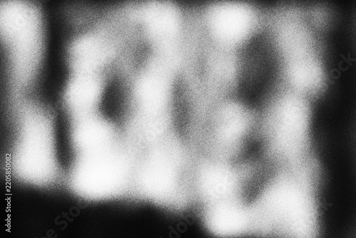 Abstract black and white blurred light texture with soft grain overlay