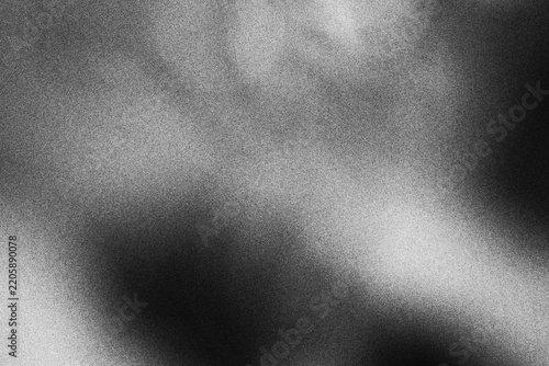 Abstract black and white grainy texture background with soft light