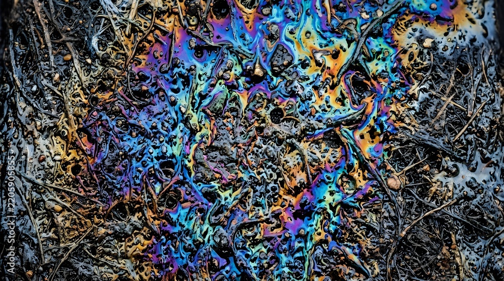 Obraz premium Iridescent rainbow oil slick contaminating natural soil and roots illustrating environmental pollution and hazardous toxic waste spills