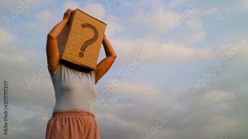 Person wearing a cardboard box with a question mark over their head, symbolizing confusion and uncertainty.