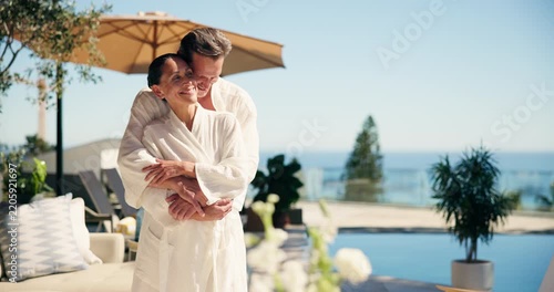 Couple, relax and smile at resort with hug, bonding and partner on anniversary and holiday. Embrace, vacation and happy mature people on getaway with love, commitment and honeymoon by hotel pool