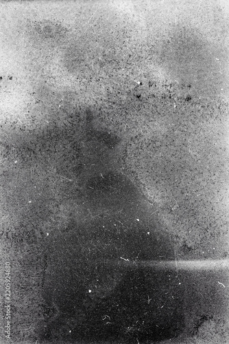 Blank grained film strip texture background with heavy grain, dust and light leak. Old expired soviet moldy photographic film scan. Black and white.