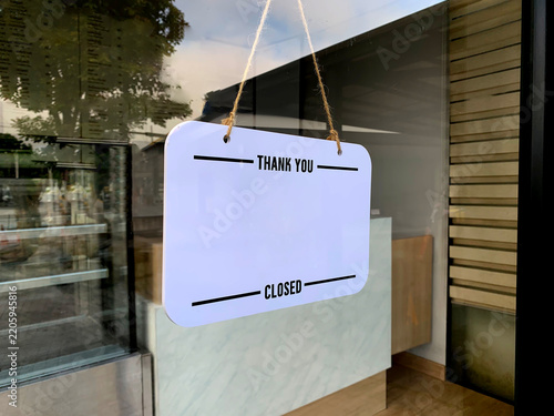Closed Sign with Thank You Text Hanging on Shop Glass Door