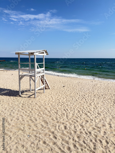 Observation deck by the seashore. Lifeguard platform by the sea. Sea, breeze, waves, blue sky, sand
