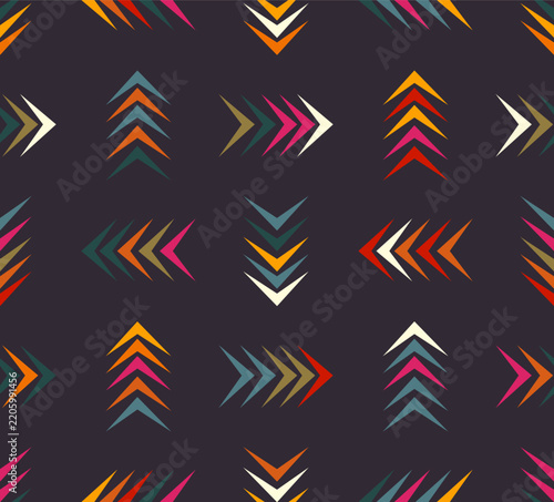 Tribal arrow seamless pattern with colorful chevron shapes on dark background for fabric wallpaper textile print.