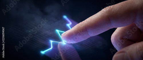 A fingertip touches a glowing blue growth chart in extreme macro close-up view