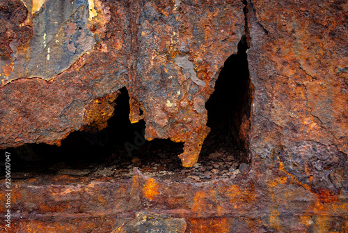 Obraz na plátně Heavily rusted corroded metal plate texture with a hole background