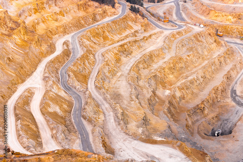 Geamana, Romania - 21 September 2026: Aerial view of the terraced landscape and winding dirt roads of the Geamana copper mine tailings area in Alba County.