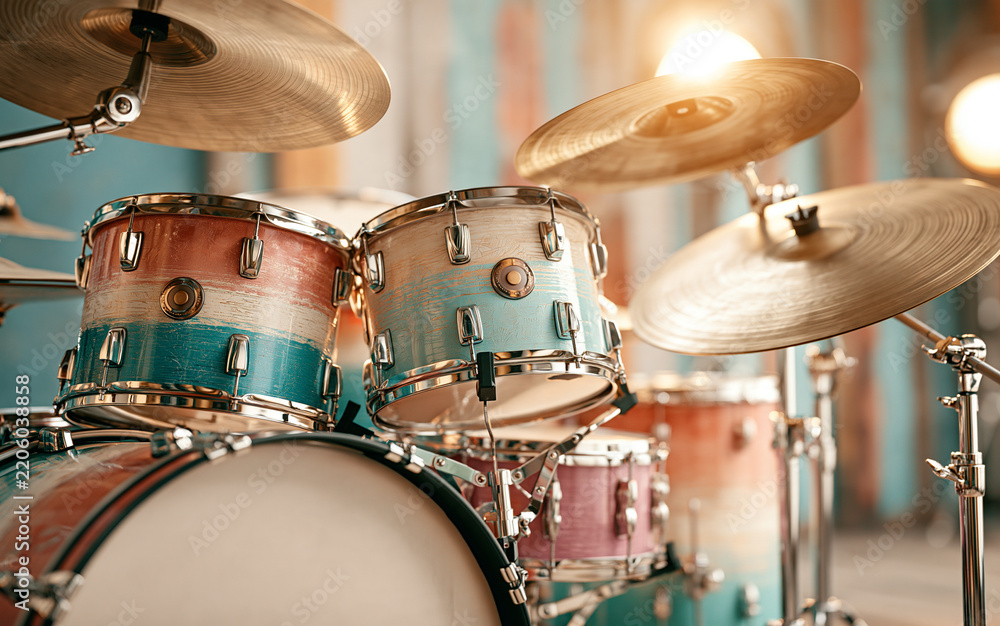 Fototapeta premium a drum kit in a music studio, cymbals catching light, colorful drum shells, soft studio lighting