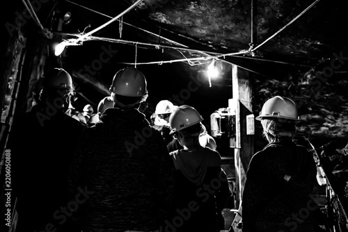 Selective focus on anthracite coal on a conveyer belt with defocused group in the Lackawanna Coal Mine Tour at McDade Park.