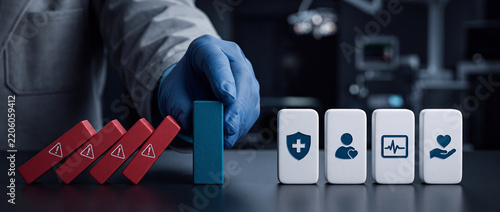 Healthcare Professional in Blue Glove Stopping Falling Red Dominoes with Warning Signs to Protect Patient Safety and Medical Icons Representing Clinical Risk Management and Crisis Prevention